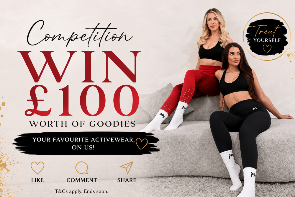 Promotional banner for a £100 competition to win favorite activewear on the brand. Two women in activewear (one in red leggings and one in black leggings) are sitting on a gray sofa, with large text reading 'Competition WIN £100 WORTH OF GOODIES' and social media icons at the bottom.